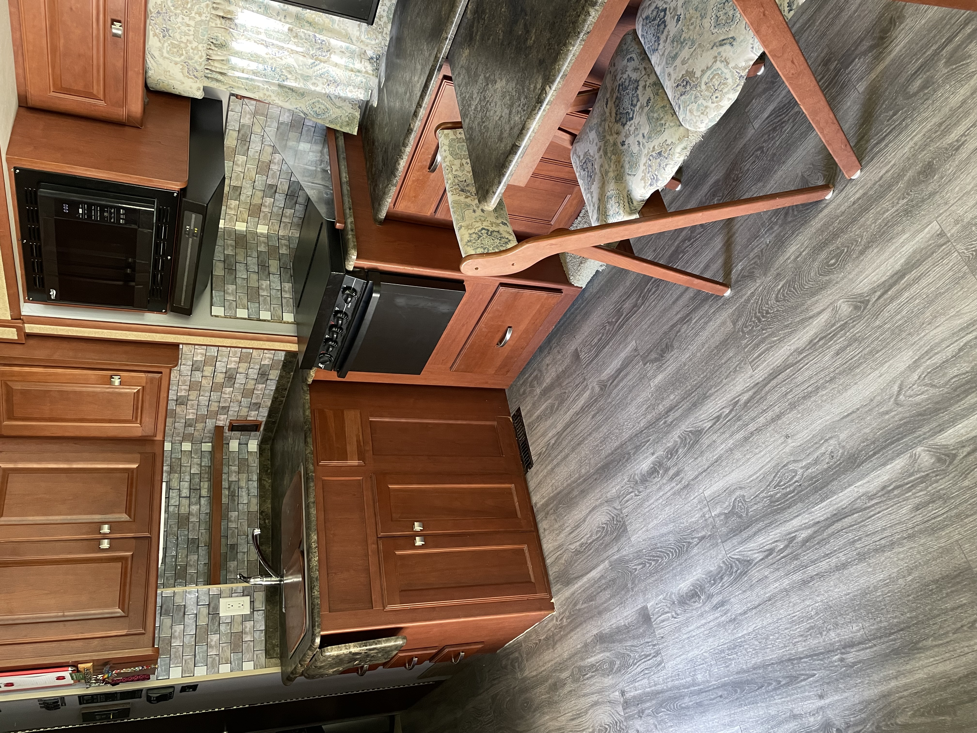 Kitchen showing new microwave and upgraded flooring